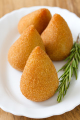 appetizer on white plate on brown background