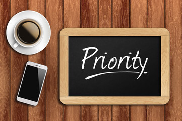 coffee, phone  and chalkboard with  word priority