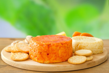cheese with cookies on wooden background