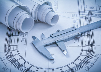 Construction drawings metal caliper on blueprint architecture an