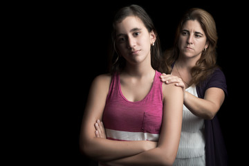 Sad teen girl with her mother offering help