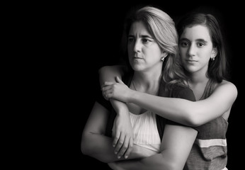 Fototapeta premium Sad and angry mother with daughter embracing her