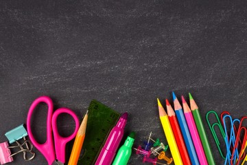 School supplies bottom border on a chalkboard background