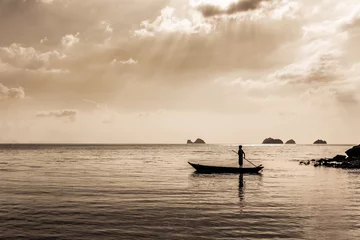 Foto auf Alu-Dibond silhouette of Fisherman controls the Fishing boat. sepia toned © dima266f