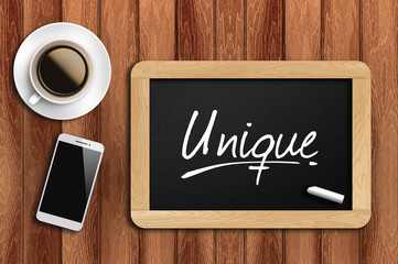 coffee, phone  and chalkboard with  word  unique