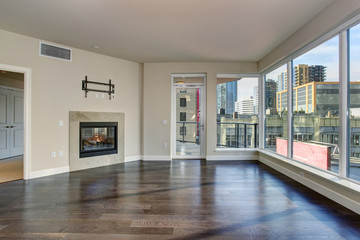 Large empty living room with fireplace.