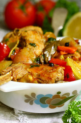 Rabbit stewed with vegetables in tomato sauce.