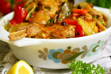 Rabbit stewed with vegetables in tomato sauce.