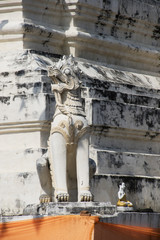 Statue of a mythical lion guards the chedi at Wat Kan Thome.Chiang Mai,Thailand