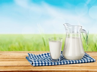 Milk, glass, tablecloth.