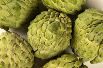 Some Sugar-Apples over a wooden table. Atemóia