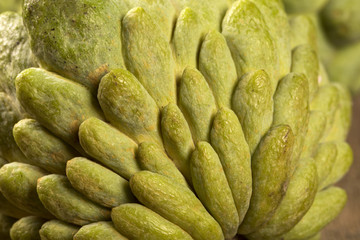 Some Sugar-Apples over a wooden table. Atemóia