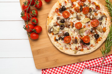 Pizza with bacon, olives and tomato