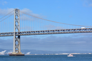 Fishing boat sail under Oakland Bay Bridge