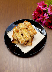 Herbs garlic bread on wood background vertical style