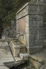 Water. Fountains in the Woods. Italy. Campania. Cilento. Gulf of Policastro. Two jets of water in a powerful body, red brick. White stone square corner. Fresh, current, strong and cold spurts.
