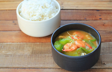 Zucchini carrot and shrimp fried on wood background
