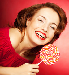 Portrait of young woman with lollipop