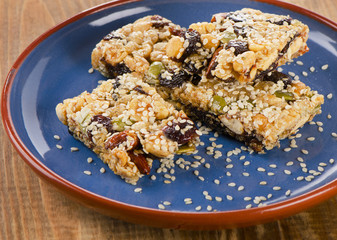 Healthy fruit and nut granola bars on  blue  plate