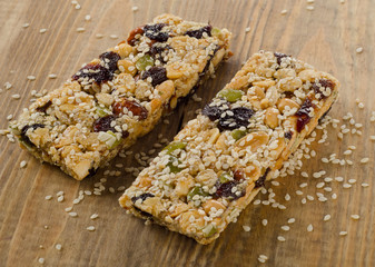 Healthy fruit and nut granola bars on  a wooden table.