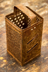 Old rusty grater. Selective focus