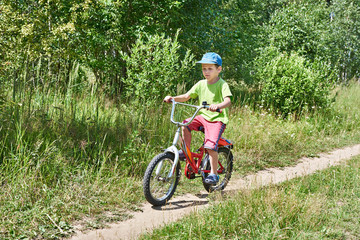 Little boy on bike ride at country road