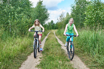 Girls on  bike ride at country road