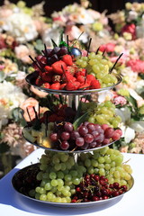 berries on festive table. strawberries, grapes, cherries on banquet