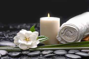 Fototapeta na wymiar Still life with gardenia flowers with candle ,towel on therapy stones 
