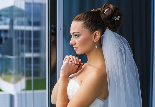 Bride are looking through the window.