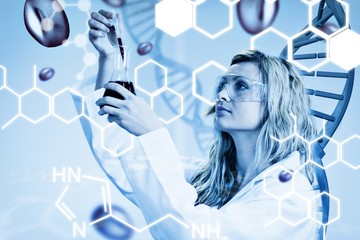Composite image of female scientist examining blood