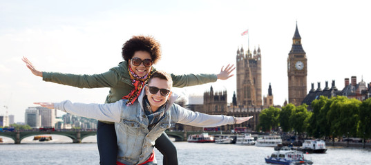 happy teenage couple having fun over london city