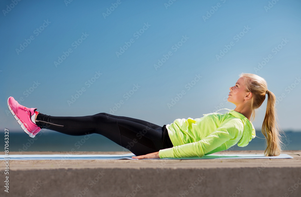 Wall mural woman doing sports outdoors