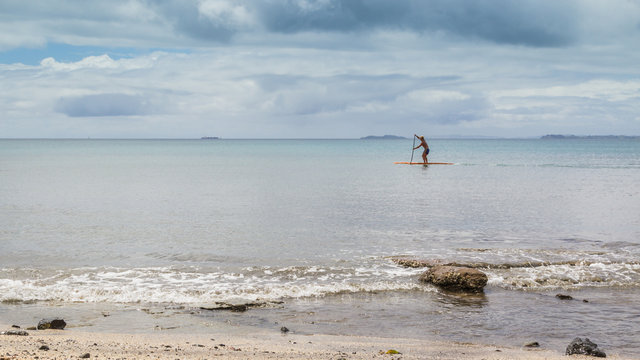 Man paddle boarding on calm water
