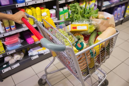woman buy products with her trolley 
