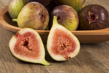 A couple of figs in a pot over a wooden table