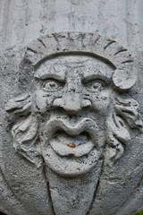 Fototapeta na wymiar Ugly stone face sculpture