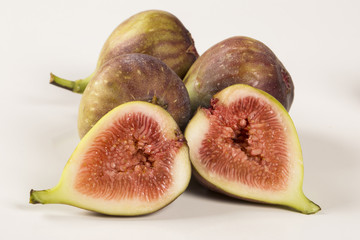 A couple of figs in a pot over a wooden table