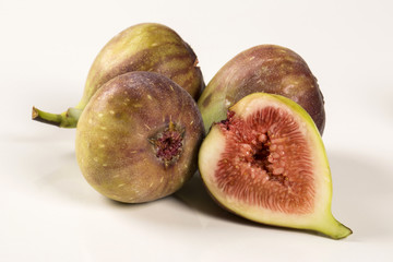 A couple of figs in a pot over a wooden table