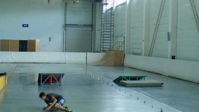 Guy roller jumps through the springboard
