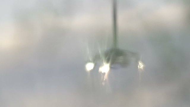 rack focus of the spotlight reflection on the water surface in the pool