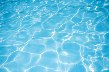 Naklejka na ściany i meble Blue water rippled background in swimming pool