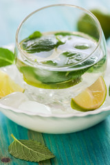 A Glass of fresh Mojito cocktail on ice cubes