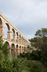 Fototapeta na wymiar Devil’s bridge Roman aqueduct built near Tarragona, Catalonia, Spain, wearing the river Francoli in the ancient city of Tarraco. One of the most monumental aqueducts and best preserved Roman times.