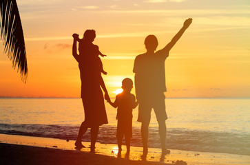 Fototapeta na wymiar happy family with two kids having fun at sunset