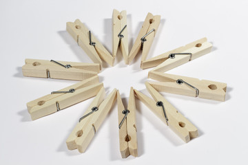 Clothespins placed to form a ten-pointed star in the center, on a white background