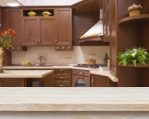 Fototapeta na wymiar Dining table on blurred brown kitchen interior background