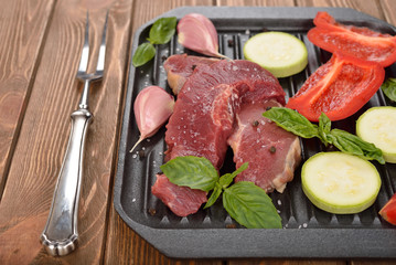 Raw steak and fresh vegetables