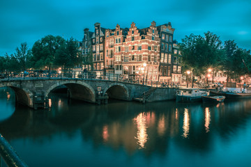 Night city view of Amsterdam canal and bridge