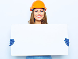 Woman hold white blank business board dressed in builder unifor